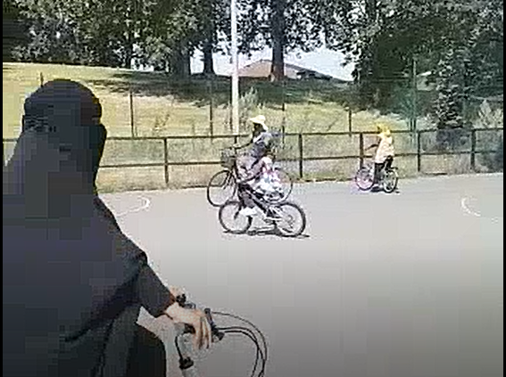 Photo of women and children cycling